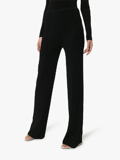 Shop Totême Cour Ribbed Knit Trousers In Black