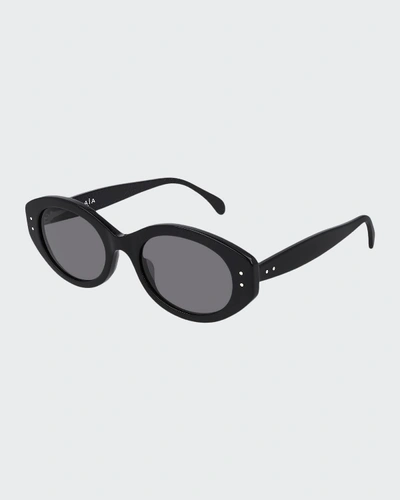 Shop Alaïa Oval Acetate Sunglasses In Black