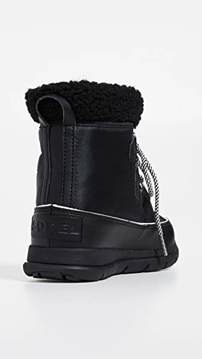 Shop Sorel Explorer Carnival Boots In Black/sea Salt