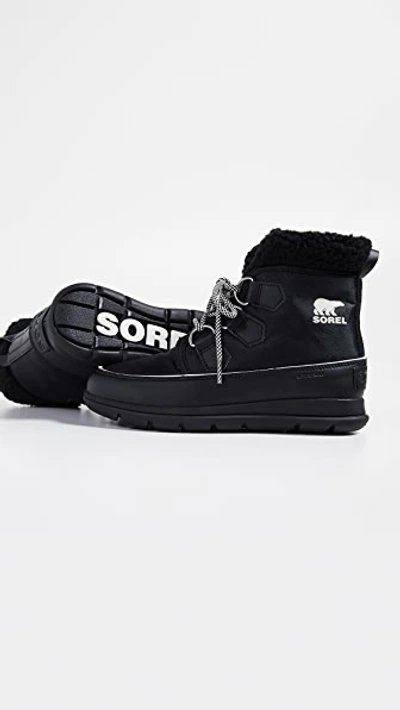 Shop Sorel Explorer Carnival Boots In Black/sea Salt