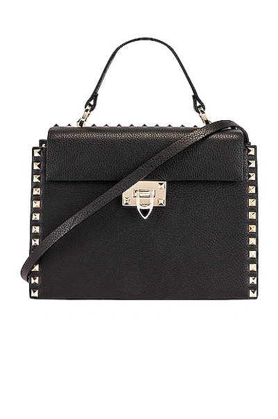 Shop Valentino Rockstud Top Handle Bag In Nero