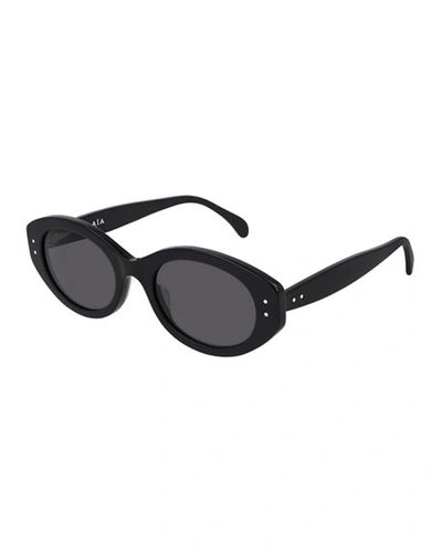Shop Alaïa Oval Acetate Sunglasses In Black