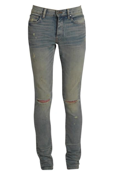 Shop Amiri Slash Knee Skinny Jeans In Dust Indigo