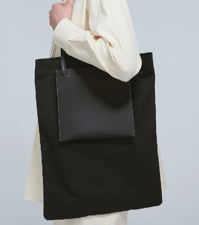 Shop Jil Sander Leather-trimmed Tote With Pockets In Black