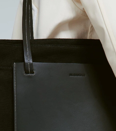 Shop Jil Sander Leather-trimmed Tote With Pockets In Black