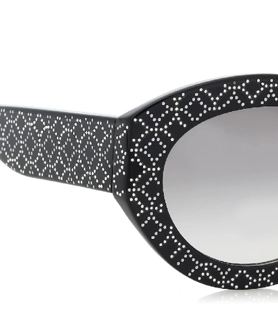 Shop Alaïa Embellished Oval Sunglasses In Black