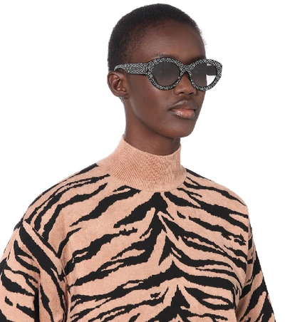 Shop Alaïa Embellished Oval Sunglasses In Black