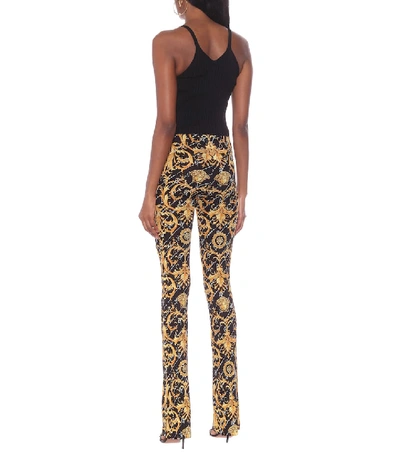 Shop Versace Printed Stretch-jersey Pants In Black