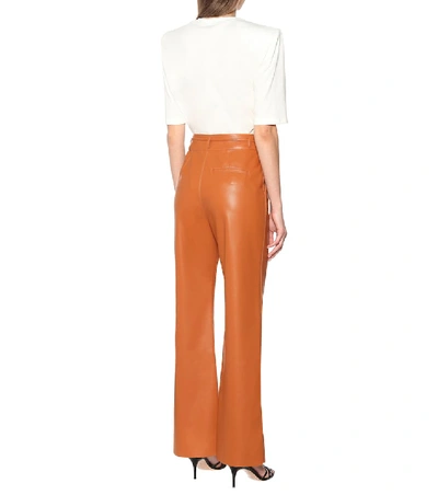 Shop Nanushka Chimo Faux Leather Wide-leg Pants In Orange