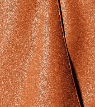 Shop Nanushka Chimo Faux Leather Wide-leg Pants In Orange