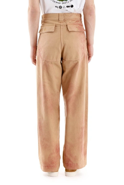 Shop Jacquemus Terraio Spray Paint Trousers In Orange