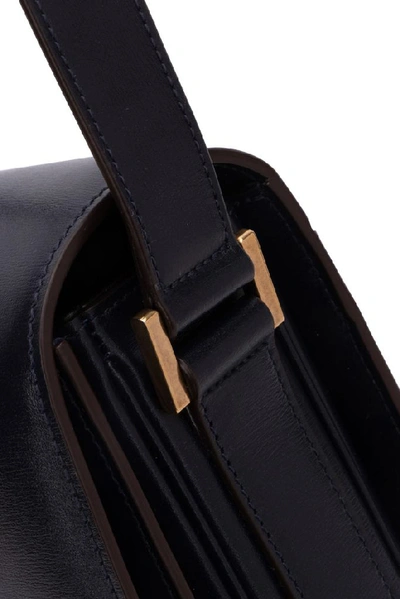 Shop Saint Laurent Logo Embossed Shoulder Bag In Black