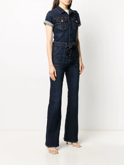 Shop Frame Belted Denim Jumpsuit In Blue