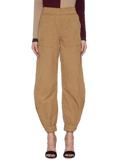 Shop Ganni Crinkled Drawstring Tech Pants In Brown