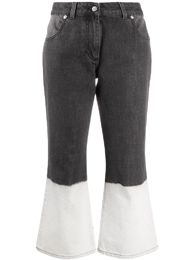 Shop Jw Anderson Bleached Hem Flared Jeans In Grey
