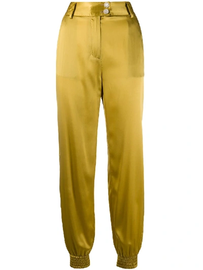 Shop Just Cavalli Engraved-button Tapered Trousers In Gold