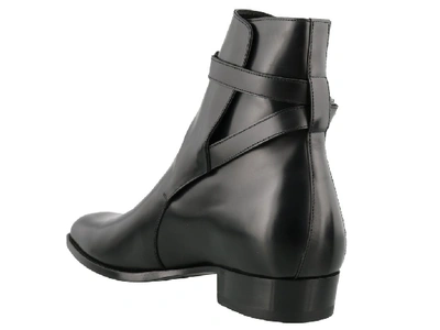 Shop Saint Laurent Wyatt Belted Boots In Black