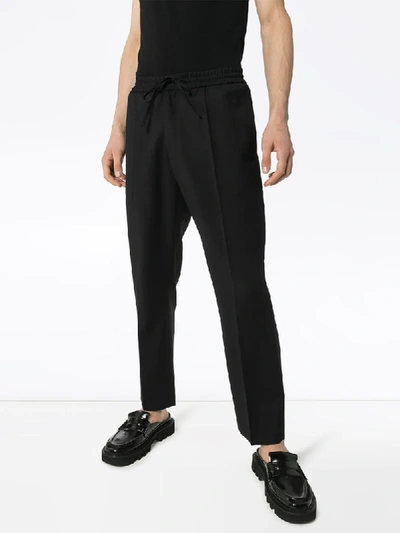 Shop Cmmn Swdn Tapered Drawstring Trousers In Black
