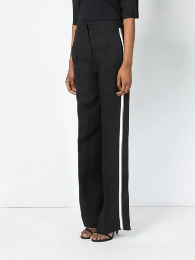 Shop Fendi Side Stripe Flared Trousers In Black
