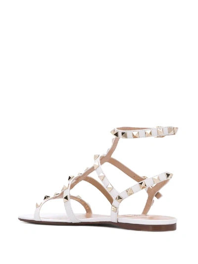 Shop Valentino Rockstud Flat Sandals In White