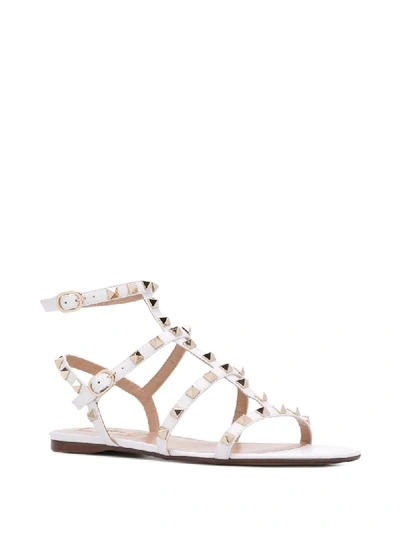 Shop Valentino Rockstud Flat Sandals In White
