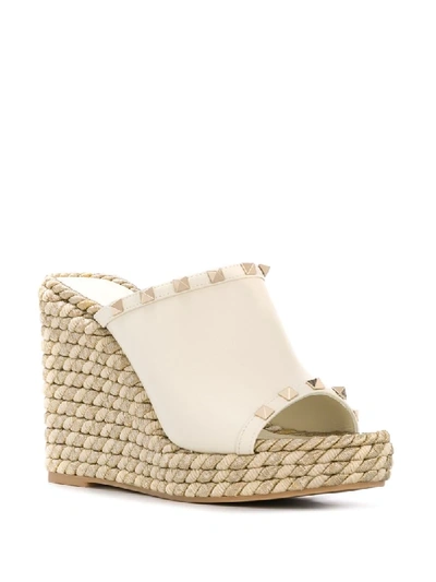 Shop Valentino Garavani Rockstud 120mm Wedge Mules In White