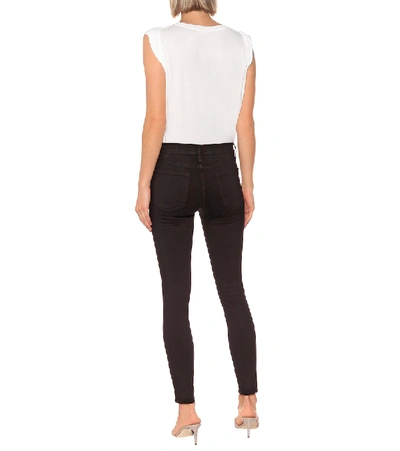 Shop Frame Le Skinny De Jeanne Mid-rise Jeans In Black