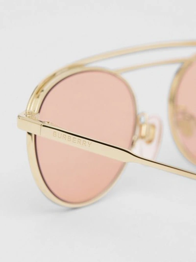 Shop Burberry Oval Frame Sunglasses In Light Pink