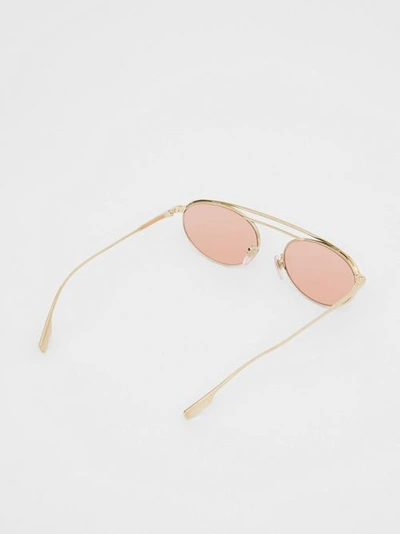 Shop Burberry Oval Frame Sunglasses In Light Pink