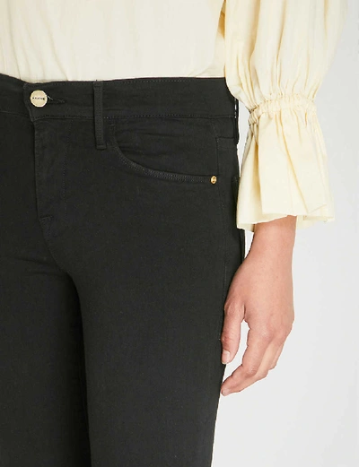 Shop Frame Le Skinny Mid-rise Jeans In Film Noir