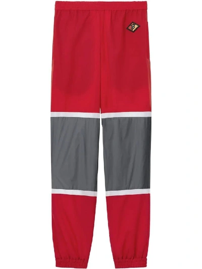 Shop Burberry Red Men's Logo Graphic Striped Nylon Trackpants