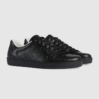 Shop Gucci Men's Ace Gg Embossed Trainer In Black