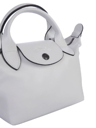 Shop Longchamp Le Pliage Cuir Top Handle Bag In White