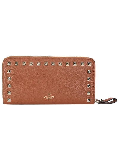 Shop Valentino Garavani Rockstud Zip Around Wallet In Brown