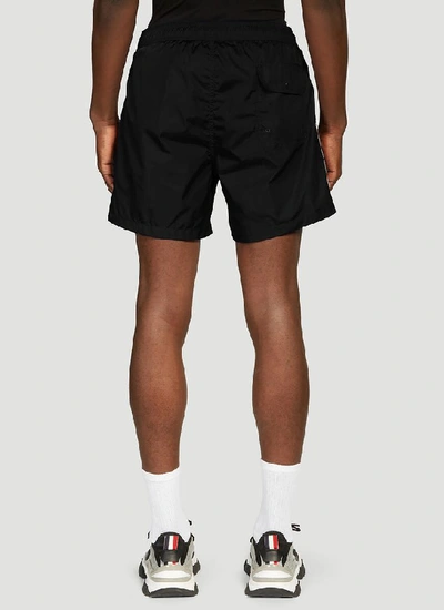 Shop Moncler Striped Logo Swim Shorts In Black