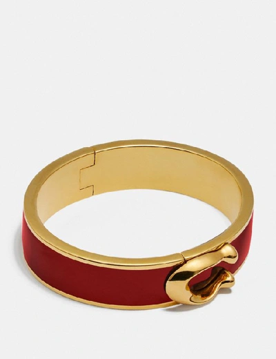Shop Coach Signature Large Hinged Bangle In Gold/red