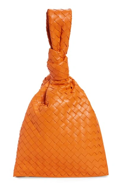 Shop Bottega Veneta Twist Intrecciato Leather Handbag In Light Orange/ Gold