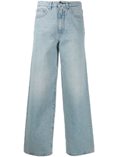 Shop Totême High Waisted Flared Jeans In Blue
