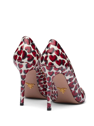 Shop Prada Hearts Print 100mm Pumps In Red