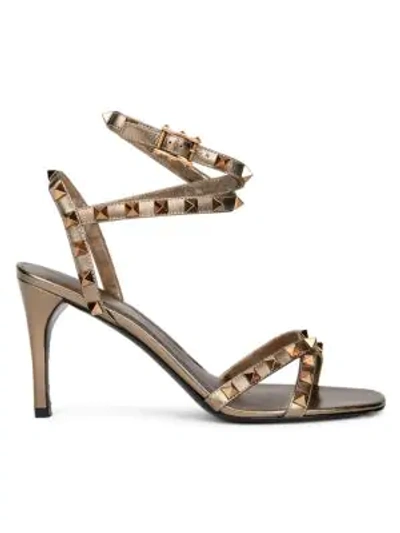 Shop Valentino Garavani Rockstud Flair Ankle-strap Metallic Leather Sandals In Sasso