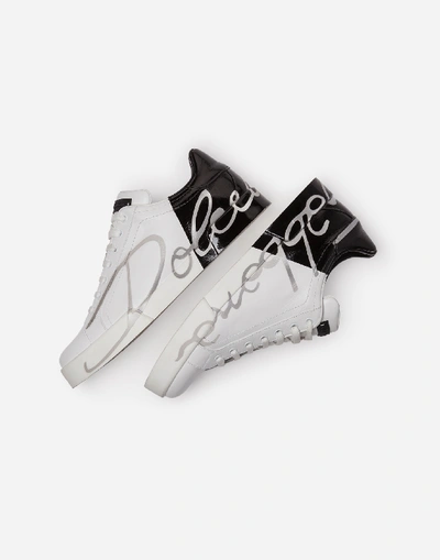 Shop Dolce & Gabbana Patent Calfskin Portofino Sneakers In White/black