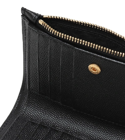 Shop Saint Laurent Monogram Zipped Leather Wallet In Black