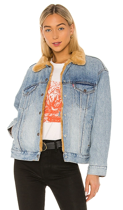 Shop Levi's Oversized Reversible Fur Trucker In Hella Indigo