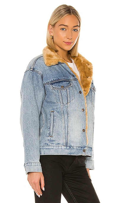 Shop Levi's Oversized Reversible Fur Trucker In Hella Indigo