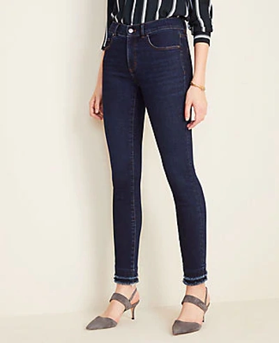 Shop Ann Taylor Petite Curvy Sculpted Pockets Frayed Skinny Jeans In Classic Mid Wash