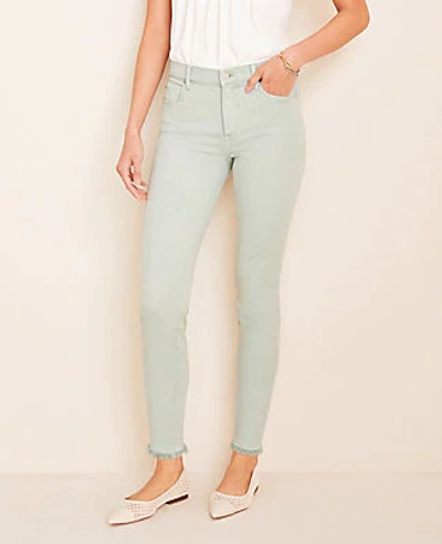 Shop Ann Taylor Petite Curvy Frayed Sculpting Pocket Skinny Crop Jeans In Icy Sage