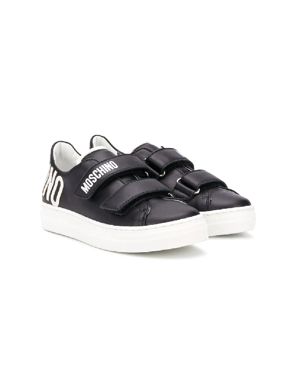 black trainers with velcro straps