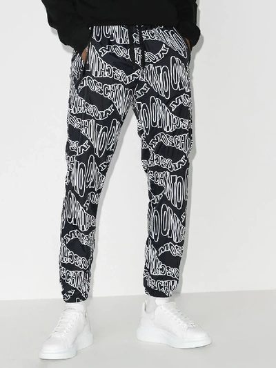 Shop Moschino Graphic Logo Track Pants In Black