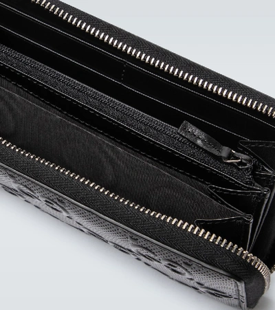 Shop Gucci Gg Embossed Full Zipped Wallet In Black