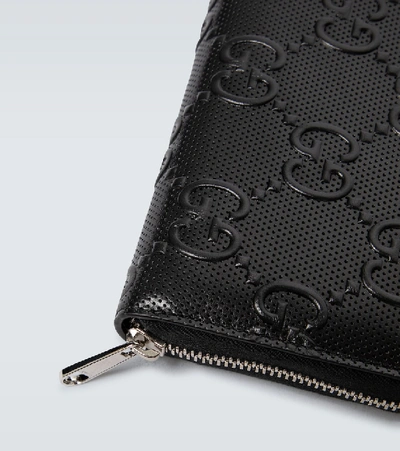 Shop Gucci Gg Embossed Full Zipped Wallet In Black